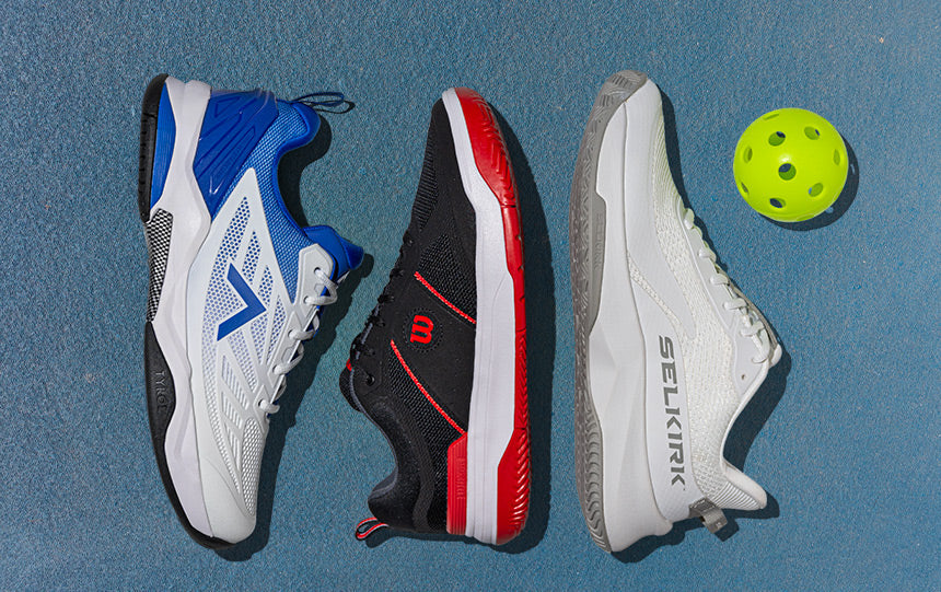 Wilson Rush Pro 3.0 Men's Black/White/Infrared Pickleball Shoes on a light blue outdoor court.