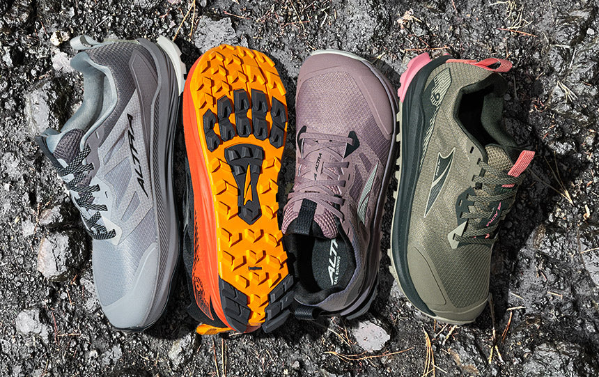 altra lone peak trail running shoes layed out on rocky trail