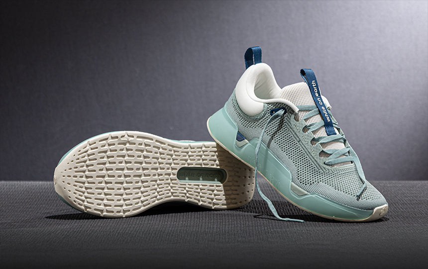 while on earth training shoes on gray background