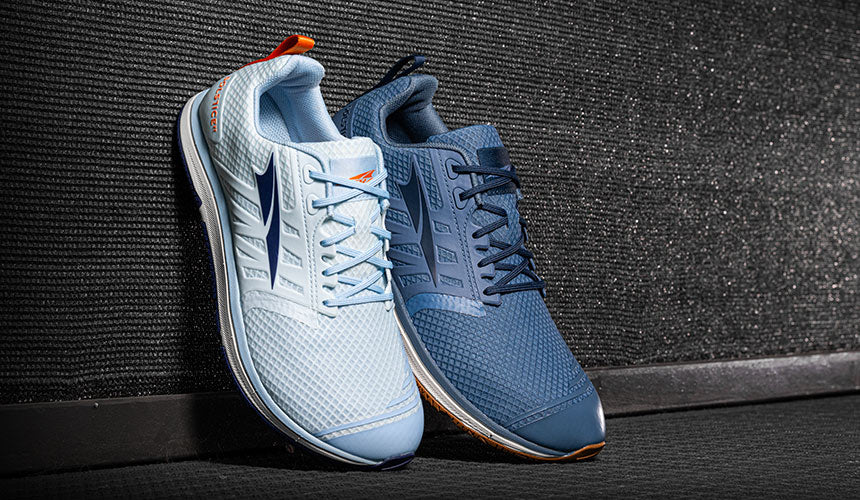 altra solstice xt 2 shoes leaning on dark wall