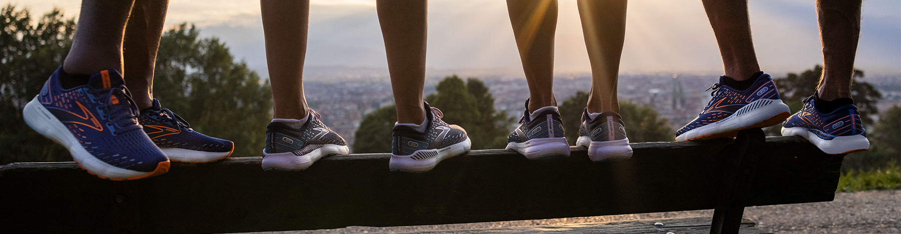 Men and women standing on a balance beam in Brooks Glycerin 20 and Glycerin GTS 20 running shoes.