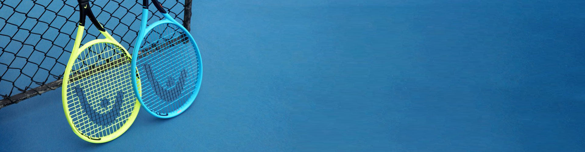 HEAD tennis racquets on blue court