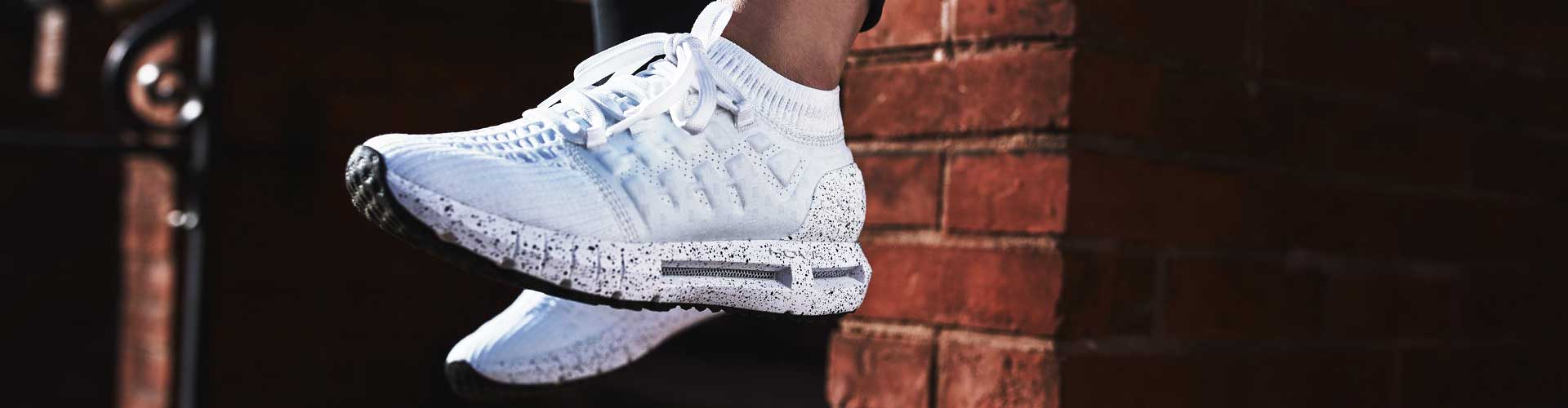 Woman in white Under Armour running shoes