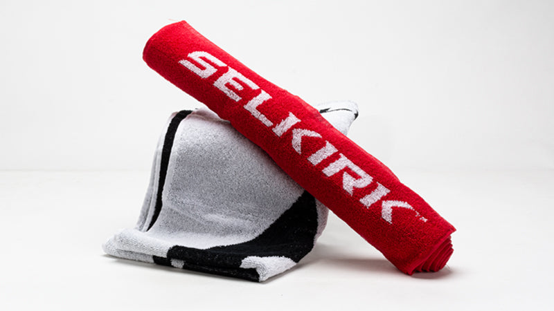 Red and white towels with 'SELKIRK' branding on a white background