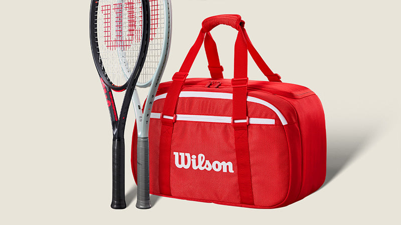 Two Wilson tennis racquets and a duffle bag