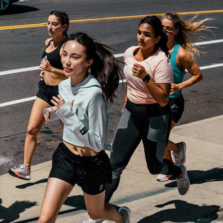 women running on sidewalk