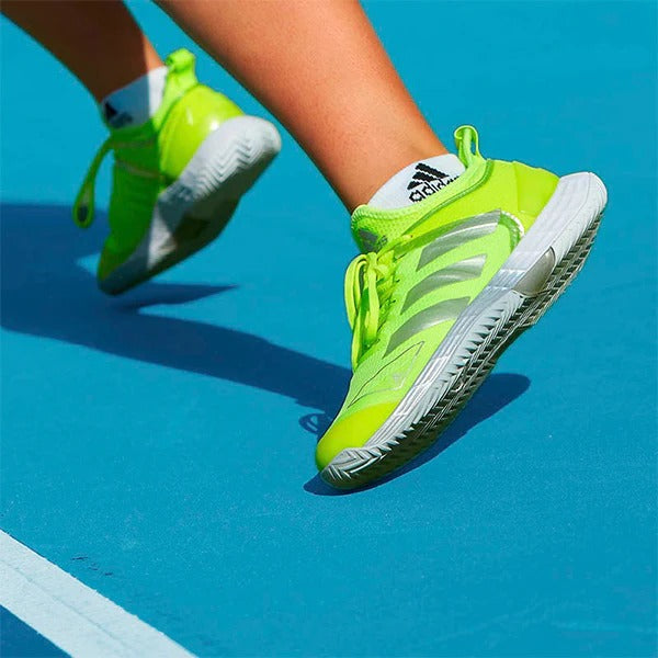 Woman wearing neon Adidas tennis shoes