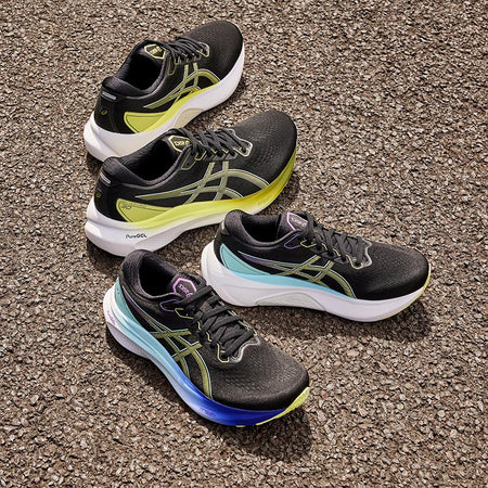 Men's and women's ASICS GEL-Kayano 30 running shoes on a paved surface.