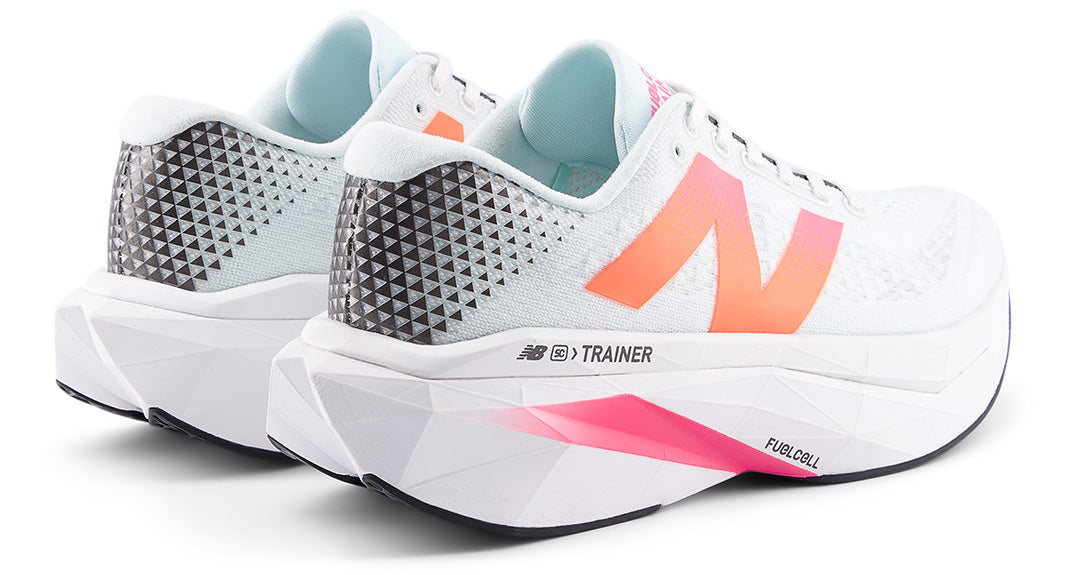 White New Balance FuelCell SuperComp Trainer v3 running shoes with pink and orange accents on a white background