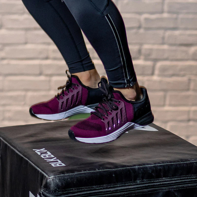 Woman wearing purple training shoes