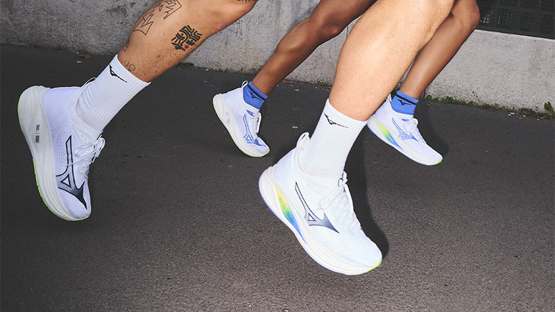 Two runners wearing white Mizuno Neo Zen 2 shoes on dark pavement
