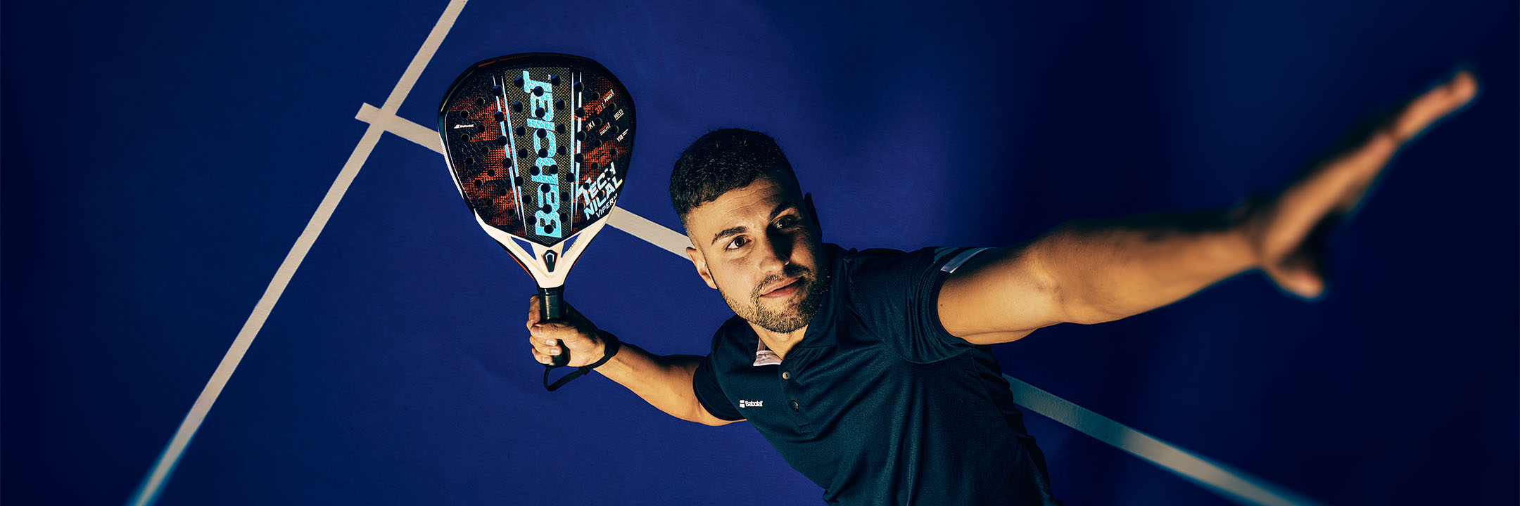 Man playing padel on a blue court with a Babolat Technical Viper padel racquet
