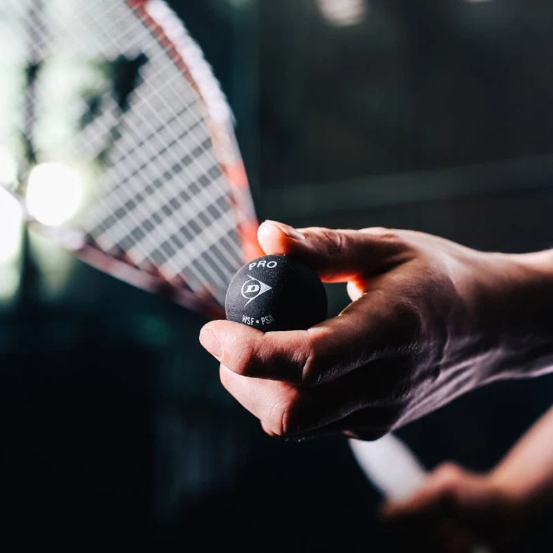 Man holding squash ball