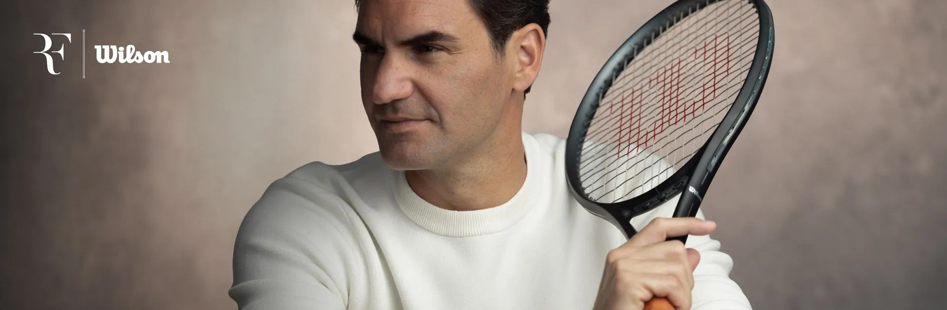 An image showing tennis legend Roger Federer holding the RF 01 tennis racquet designed in collaboration with Wilson