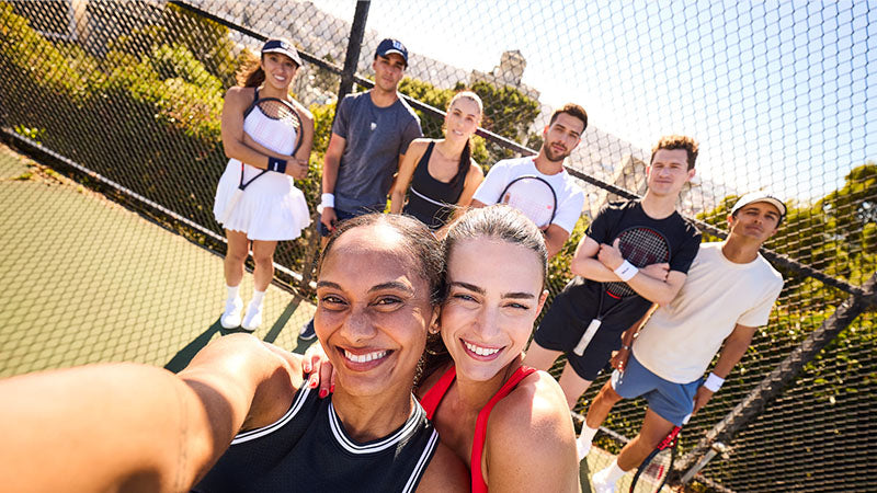 A group selfie of several tennis players holding Wilson Clash v3 racquets
