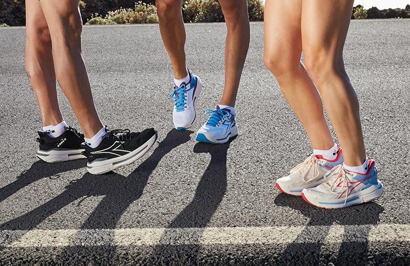 Three runners standing on the side of a road in Diadora Cellula running shoes.
