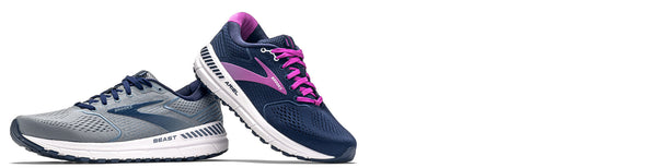 brooks beast and ariel running shoes on white background