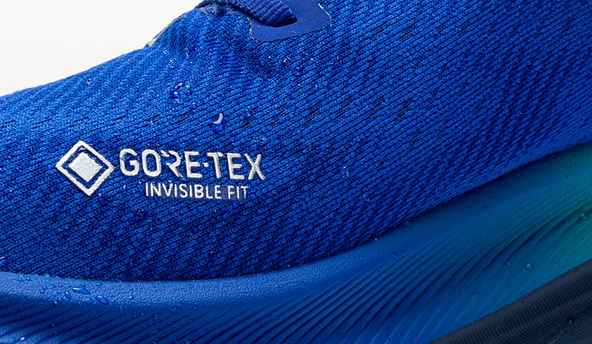 detail photograph of gore-tex logo with water droplets on clifton 9 running shoe upper