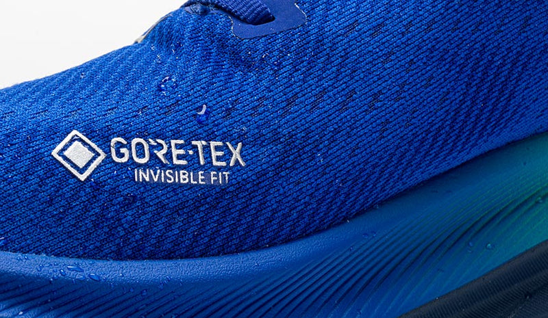 detail photograph of gore-tex logo with water droplets on clifton 9 running shoe upper