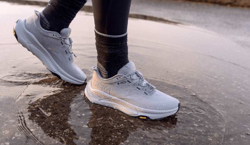 hoka transport gtx being worn while stepping in puddle. Water droplets beaded up on entire shoe.