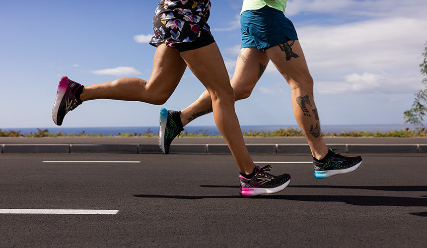 man and woman running on road along beach wearing brooks glycerin 20 running shoes