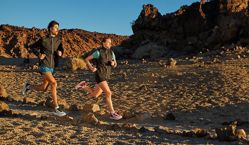 man and woman running at dusk wearing diadora mythos blushield vol 4 running shoes