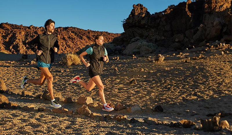 man and woman running at dusk wearing diadora mythos blushield vol 4 running shoes