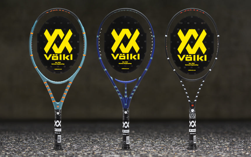 Three Volkl Vostra tennis racquets on a gray background