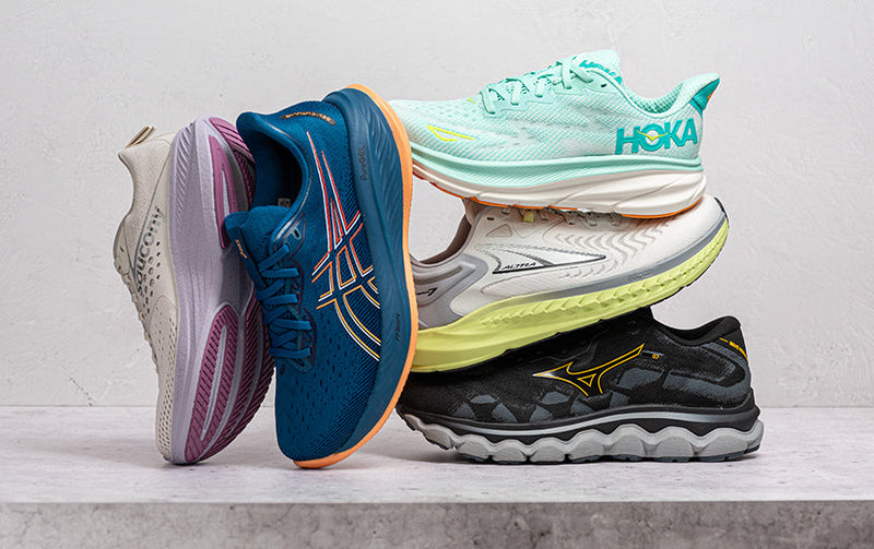 Running Shoes stacked on cement block.