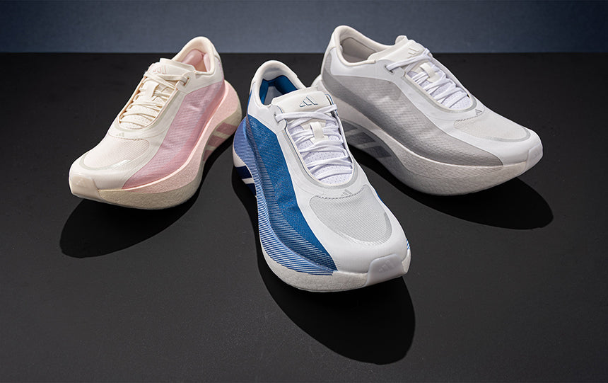 three adidas Hyperboost Edge running shoes in different colors on a dark gray background