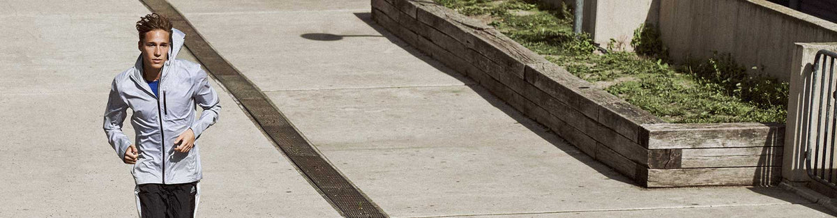 Man running outside in adidas gear
