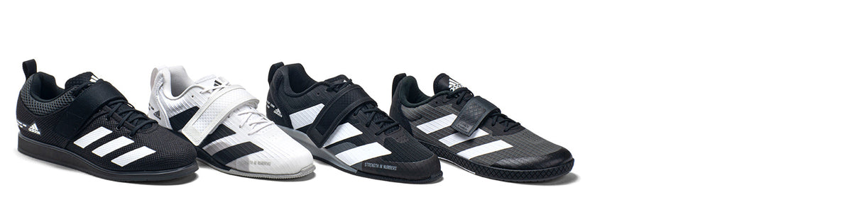 Four black and white adidas lifting shoes displayed on a clean white background.