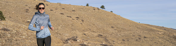 Woman running in Altra Lone Peak All-Weather Trail Running Shoes
