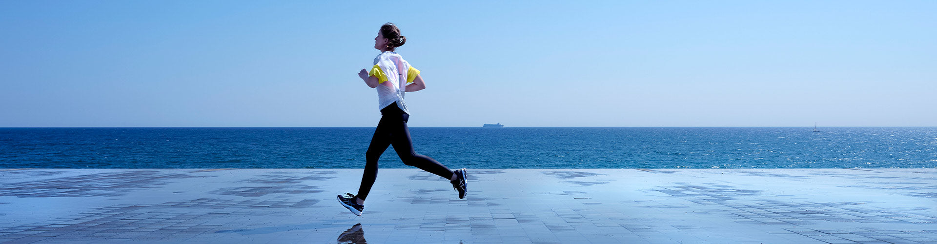 Woman running in ASICS GEL-Kayano 26