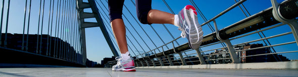 Woman running in ASICS GEL-Cumulus 21 shoes