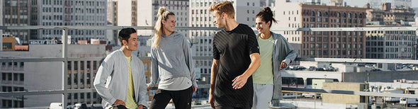 Group of people in city wearing ASICS athletic clothing