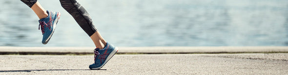 Woman running in ASICS GEL-Cumulus 20 running shoes