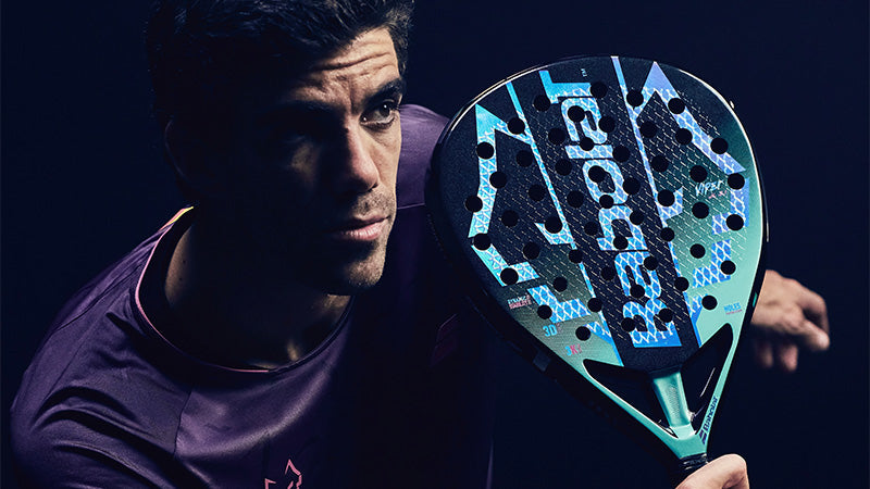 Professional padel player Juan Lebron holding a Babolat Viper Juan Lebron 3.1 paddle against a dark background