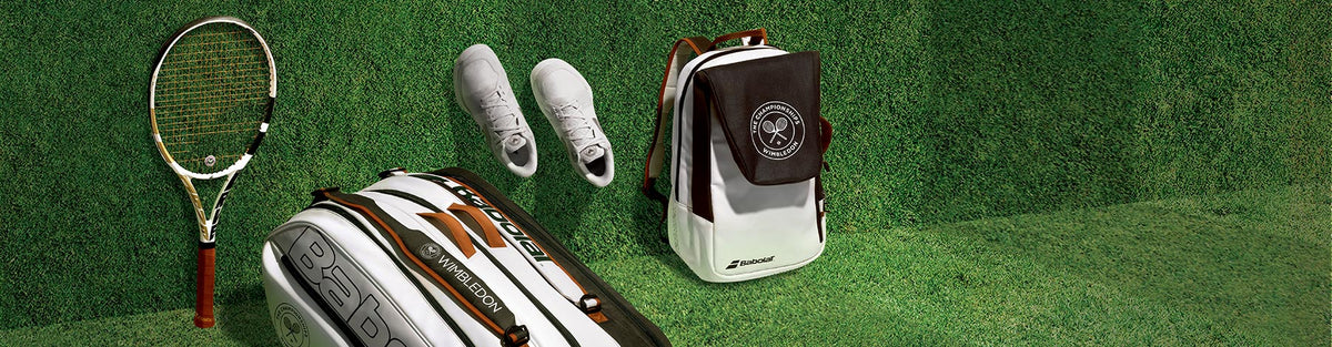 Babolat Wimbledon Collection racquet, racquet bag, shoes and backpack on a grassy background.