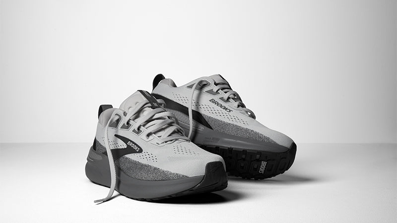 a pair of grey Brooks Beast GTS 26 men's running shoes with dark grey and black accents on a white background.