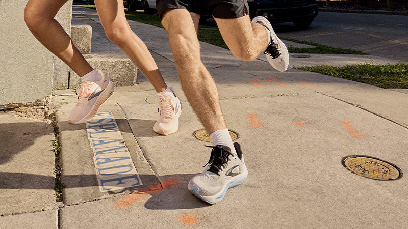 Two people running on a sidewalk wearing Brooks Ghost 18 running shoes