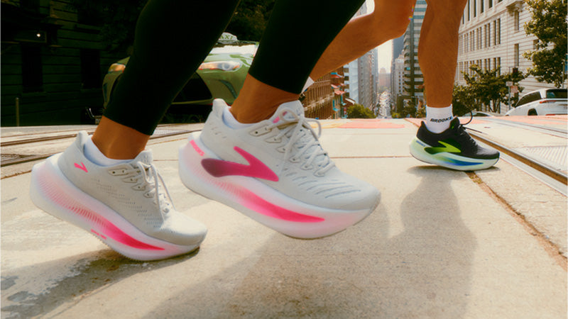 People running across a trolly track in a city wearing Brooks Glycerin Max 2 running shoes.