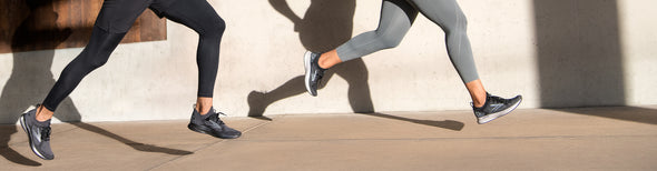 Man and woman running in Brooks Levitate Stealthfit running shoes