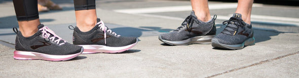 Man and woman wearing Brooks Levitate 2 and Ricohet running shoes