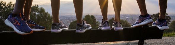 Men and women standing on a balance beam in Brooks Glycerin 20 and Glycerin GTS 20 running shoes.
