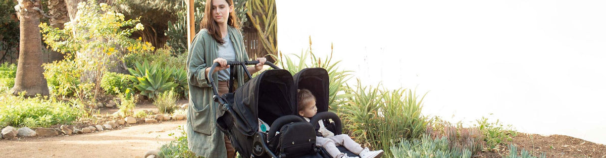 Woman pushing babies in Bumbleride Indie Twin Stroller