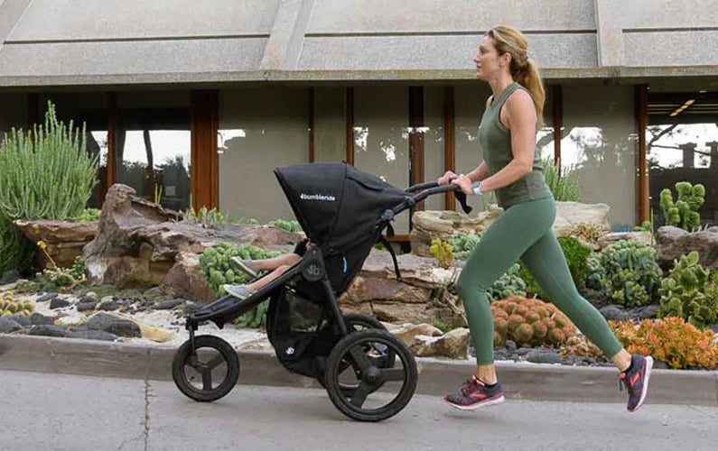 Woman running with baby in Bumbleride Speed Jogging Stroller