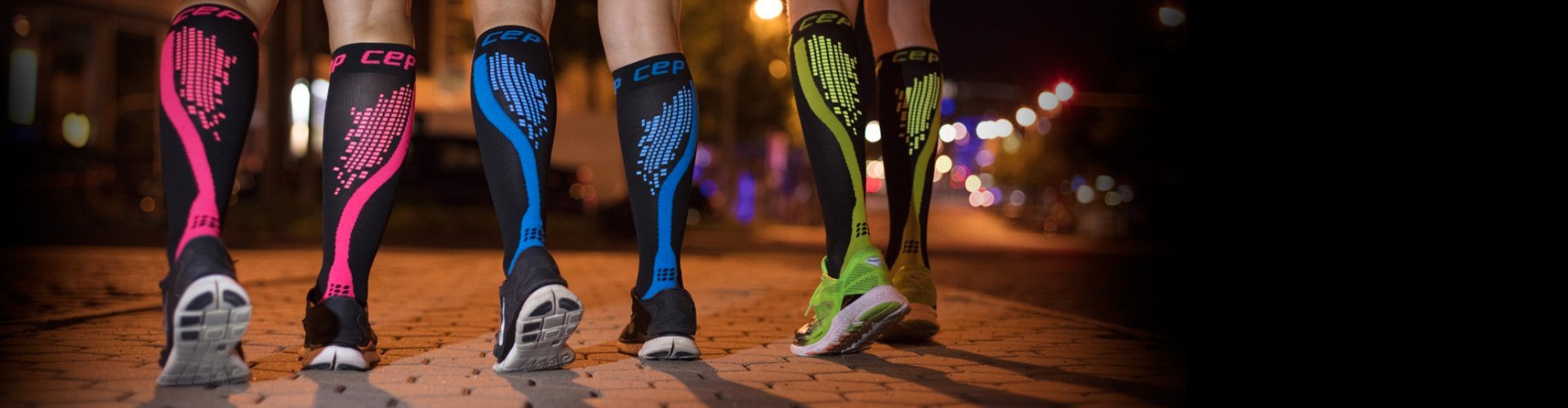 Group of people wearing pink, blue, and green compression socks