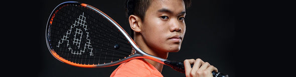 Man holding Dunlop squash racquet