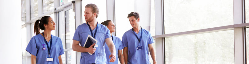 Male and female nurses walking down hallway